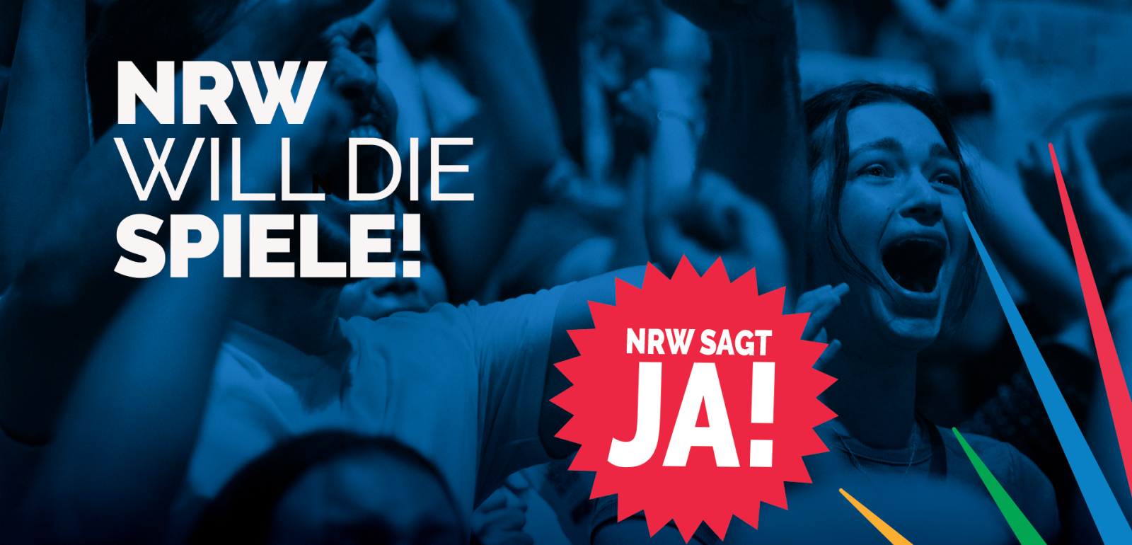 Aus einer blau getönten Menschenmenge tritt eine jubelnde Frau hervor. In fetter Schrift steht dort „NRW WILL DIE SPIELE!“, während in einem roten Sternenkranz „NRW SAGT JA!“ zu lesen ist.