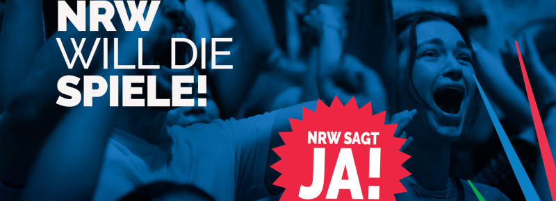 Aus einer blau getönten Menschenmenge tritt eine jubelnde Frau hervor. In fetter Schrift steht dort „NRW WILL DIE SPIELE!“, während in einem roten Sternenkranz „NRW SAGT JA!“ zu lesen ist.